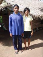 Tun and her father before their house in 2008